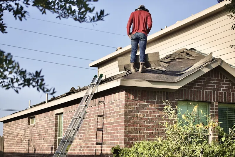 Professional roofer working on a residential roof in Robertsburg